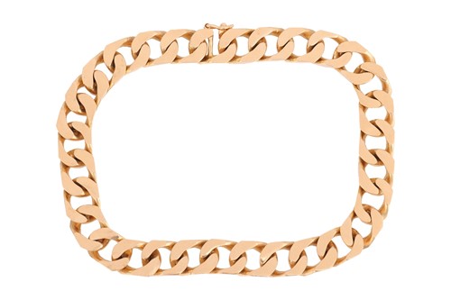 Lot 10 - A heavy flat curb link bracelet, fastens with...