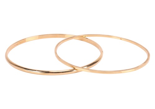 Lot Two closed bangles, the first composed of a...