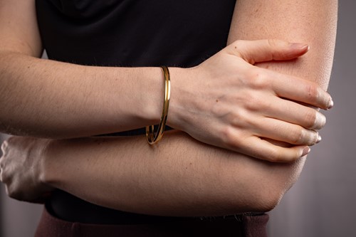 Lot Two closed bangles, the first composed of a...