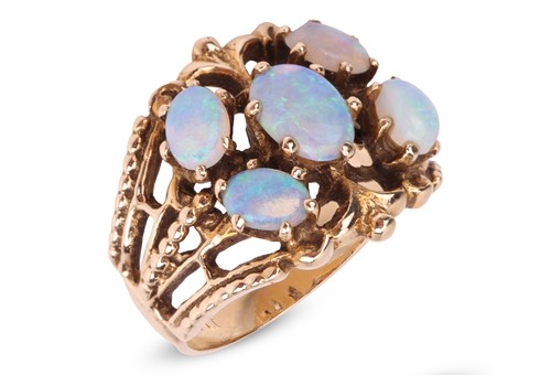 Lot 4 - An opal cluster ring, the openwork mount with...