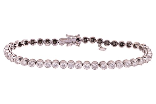 Lot 118 - A diamond-set tennis bracelet, bezel-set with...