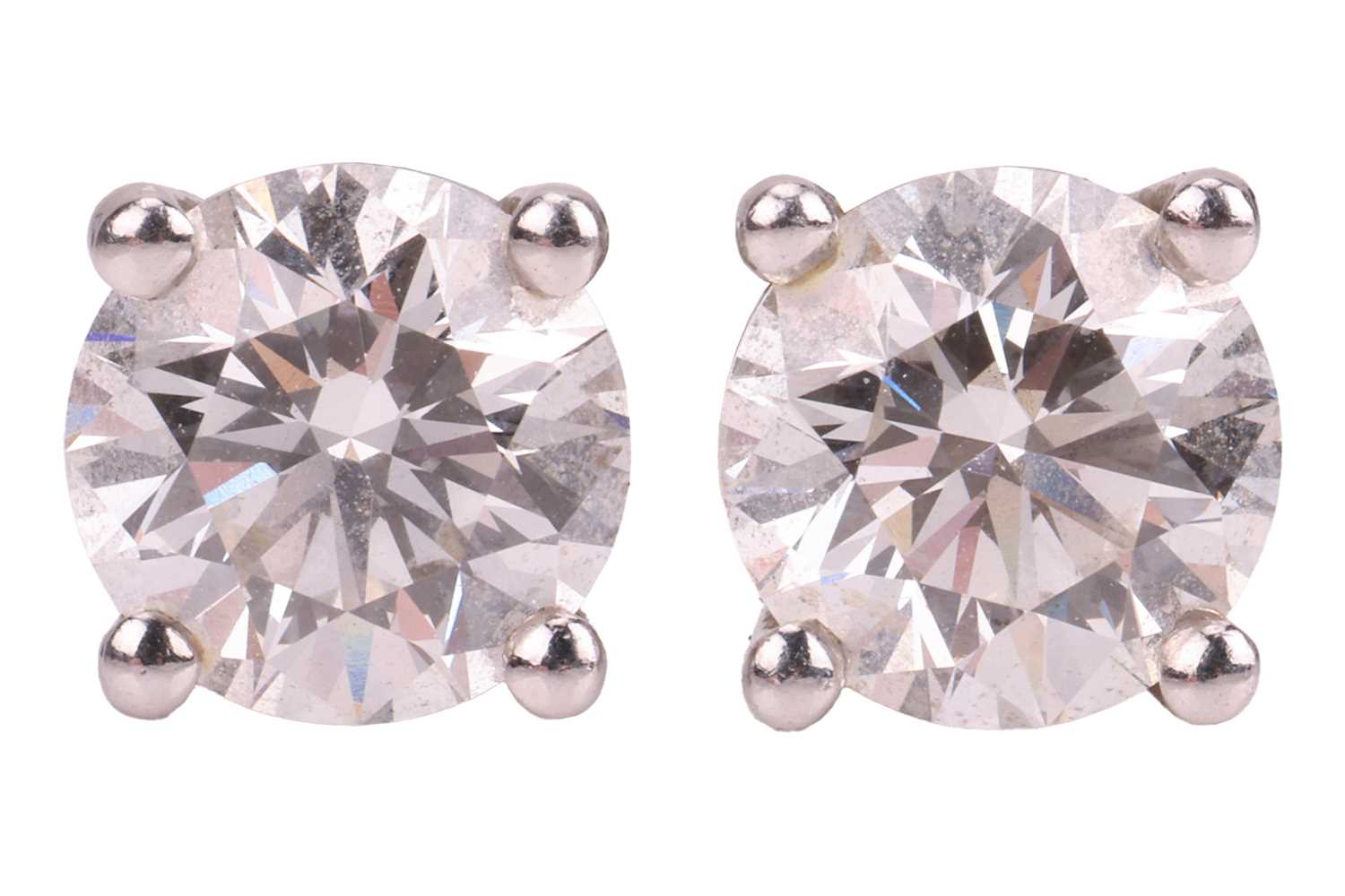 Lot 235 - Tiffany & Co. - a pair of single stone diamond...