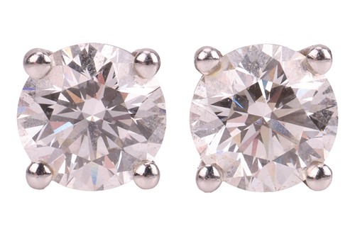 Lot 235 - Tiffany & Co. - a pair of single stone diamond...