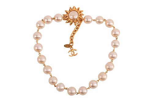 Lot 252 - Chanel - a faux pearl necklace with sunburst...