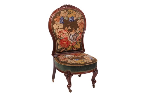 Lot 34 - A Victorian rosewood fireside chair, with...
