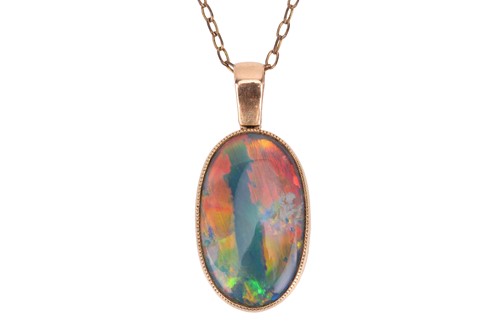Lot 175 - A black opal pendant on chain, the oval-shaped...