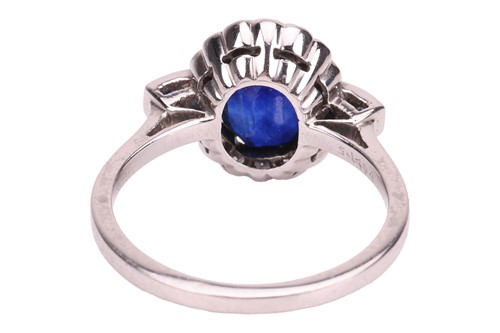 Lot 46 - A sapphire and diamond cluster ring; the oval...