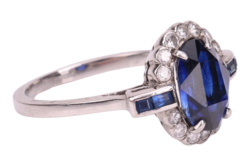 Lot 46 - A sapphire and diamond cluster ring; the oval...