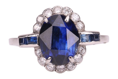 Lot 46 - A sapphire and diamond cluster ring; the oval...