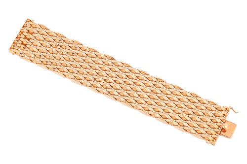 Lot 294 - A wide fancy link bracelet, comprising a...