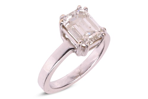 Lot 83 - A single stone emerald-cut diamond ring, the...