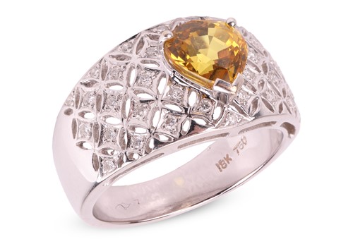 Lot 144 - A yellow sapphire and diamond-set dress ring,...
