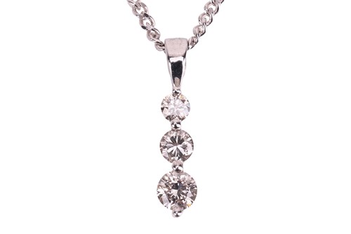 Lot 170 - A three-stone diamond pendant, claw-set with...