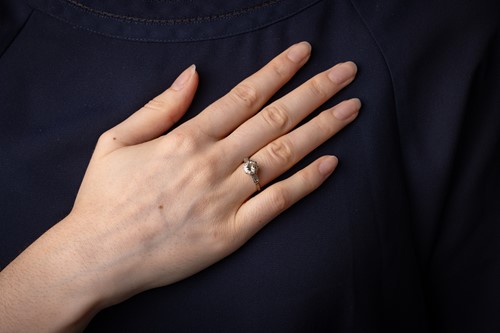 Lot 47 - A diamond solitaire ring, the central diamond...