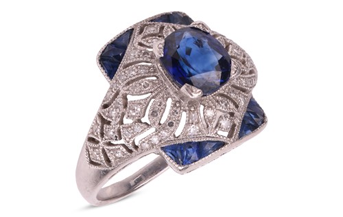 Lot 50 - A sapphire and diamond panel ring, centred...