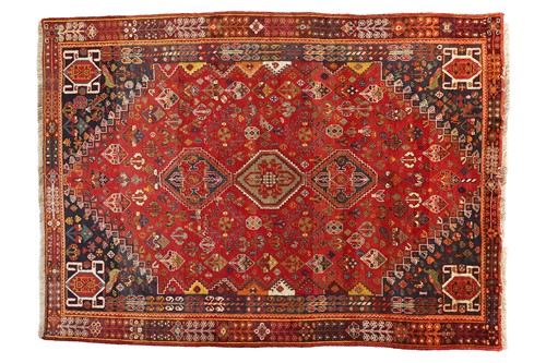Lot 77 - A Pershian Qashqai carpet, with red field and...