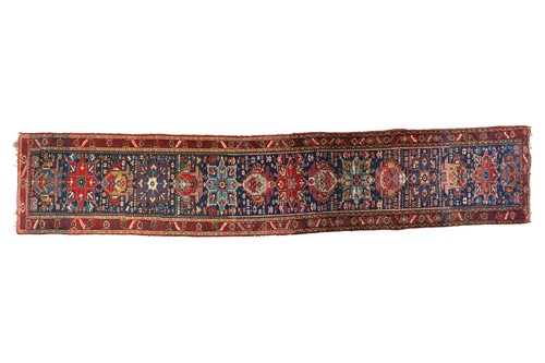 Lot 71 - A Caucasian runner, with blue field and floral...