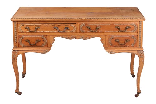 Lot 13 - A French pine kneehole writing table, applied...
