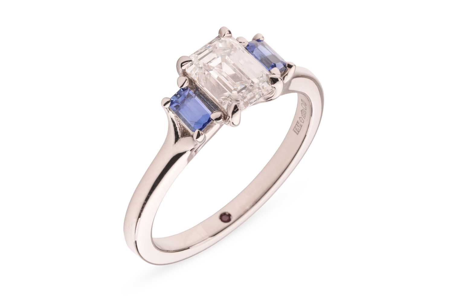 Lot 296 - A diamond and sapphire trilogy ring, featuring...