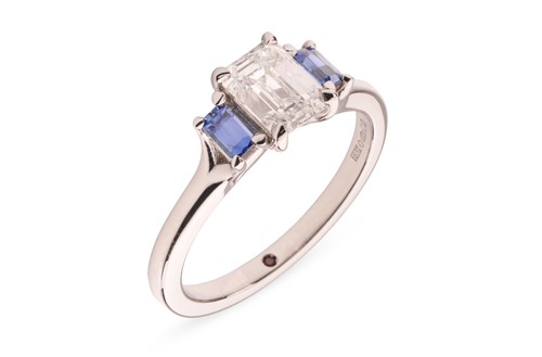 Lot 296 - A diamond and sapphire trilogy ring, featuring...