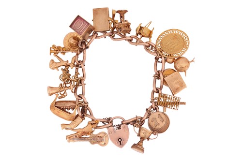 Lot 122 - A 9ct gold charm bracelet, suspending twenty...