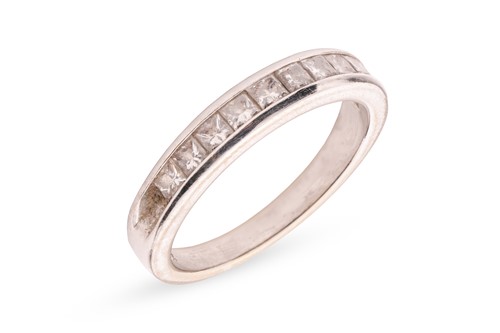 Lot 284 - A princess-cut diamond half eternity ring,...
