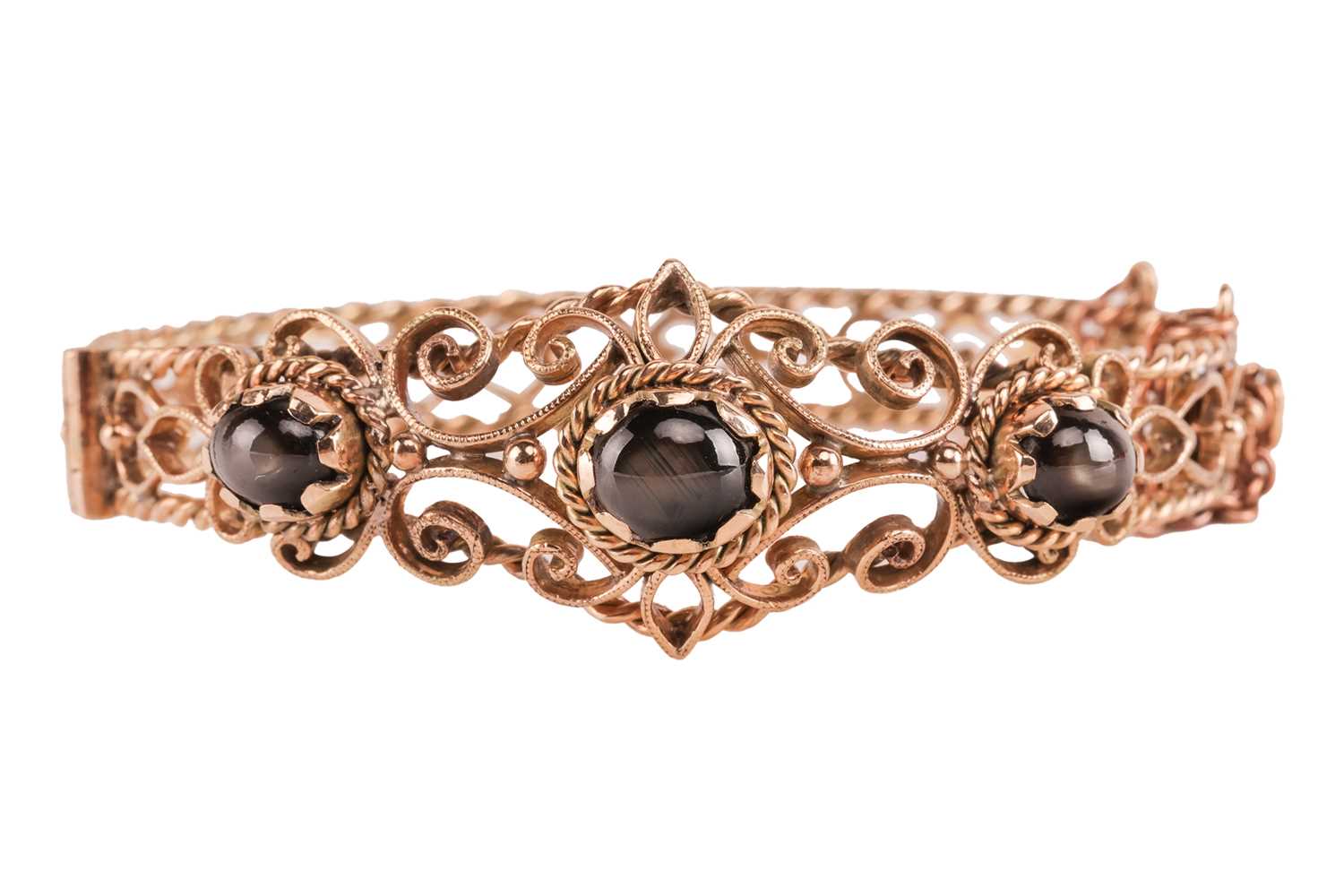 Lot 33 - A hinged bracelet set with black star...