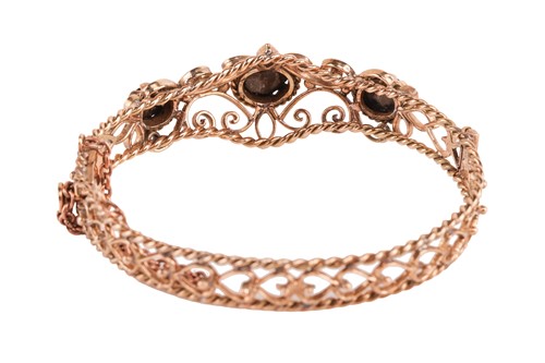 Lot 33 - A hinged bracelet set with black star...