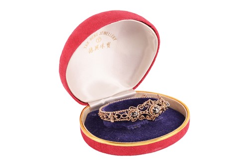 Lot 33 - A hinged bracelet set with black star...