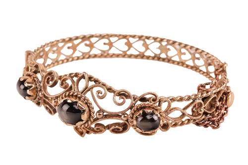 Lot 33 - A hinged bracelet set with black star...