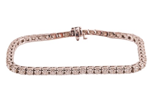 Lot 202 - A diamond line bracelet, comprising fifty-two...