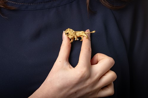 Lot 59 - A lion statant brooch, realistically sculpted...