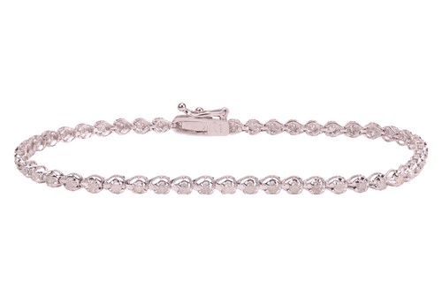 Lot 10 - A white sapphire line bracelet, comprising a...