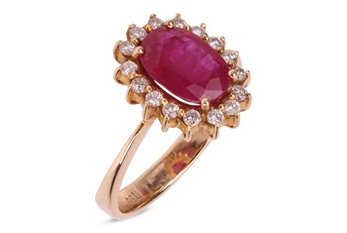 Lot 181 - A ruby and diamond-set cluster ring, centred...