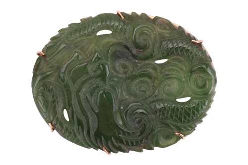 Lot 55 - A mottled dark green nephrite jade panel...