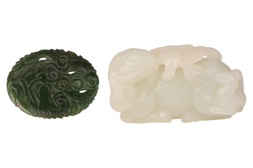 Lot 140 - A Chinese celadon jade carving of a recumbent...