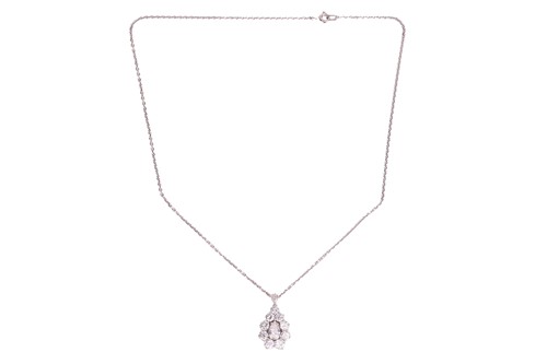 Lot 295 - A diamond cluster pendant on chain, with an...