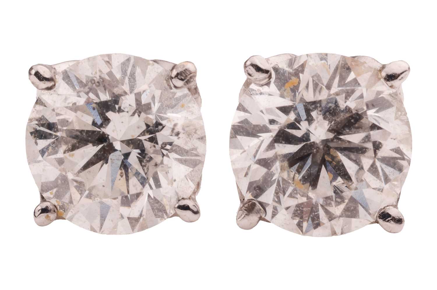 Lot 102 - A pair of diamond stud earrings, each earring...