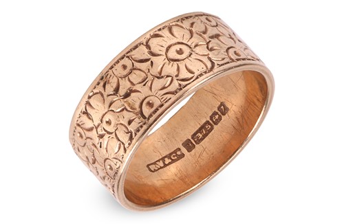 Lot 82 - An engraved floral band ring in 9ct yellow...