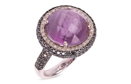 Lot 129 - An amethyst and diamond dress ring, featuring...