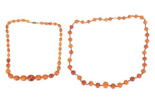 Lot 21 - Two reconstituted amber bead necklaces; the...