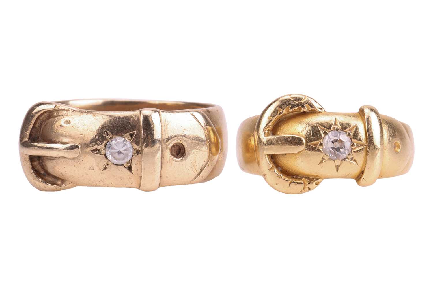 Lot 11 - Two gold buckle rings; the first star-set with...