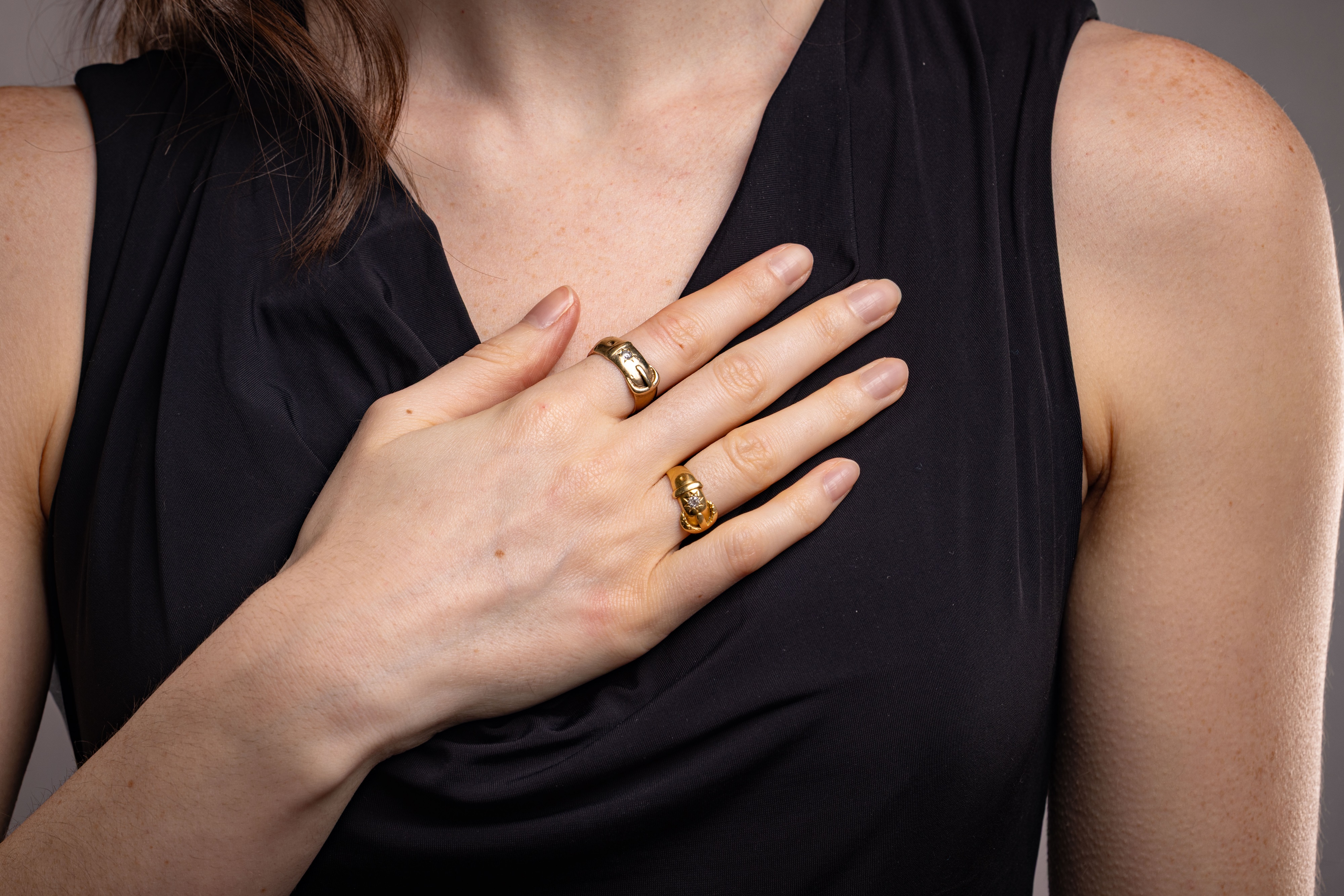 Lot 11 - Two gold buckle rings; the first star-set