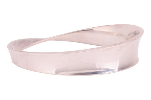 Lot 175 - Georg Jensen - A silver 'Möbius' closed bangle,...