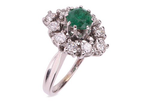 Lot 154 - An emerald and diamond-set cluster ring,...