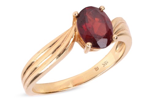 Lot 161 - A garnet-set ring, featuring a central...