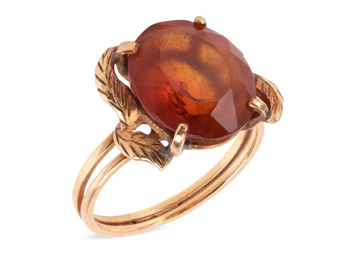 Lot 70 - A citrine dress ring, featuring a central oval...