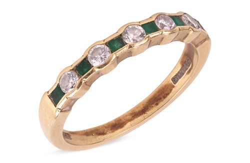 Lot 42 - An emerald and diamond half eternity ring,...