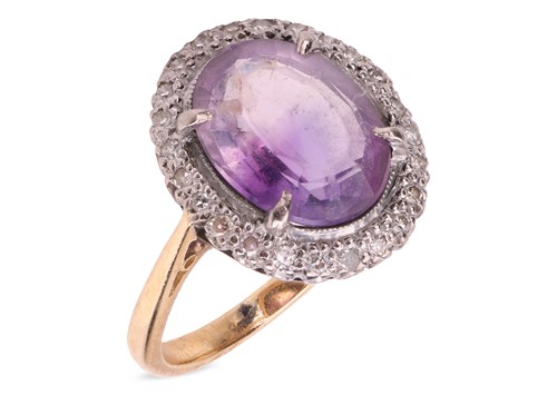 Lot An amethyst and diamond halo ring, claw-set...