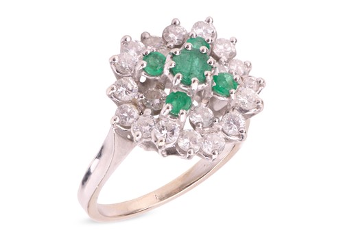 Lot 65 - An emerald and diamond cluster ring; openwork...